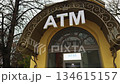 Historic ATM exterior, Urban street scene featuring ATM with bright signage and decorative arch framing Historic ATM exterior, Urban street scene featuring ATM with bright signage and decorative arch framing 134615157