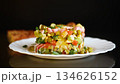 Classic Olivier salad with mixed vegetables on a black background 134626152