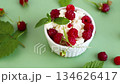 Healthy breakfast of cottage cheese with ripe raspberries 134626417
