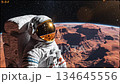 Astronaut Floating in Orbit Above a Red Planet 134645556