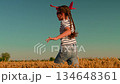 Little girl plays with toy airplane, dreaming fly. Child aviator dreams air travel. Happy girl runs with toy airplane through wheat field. Child dreams of taking to skies becoming pilot. Slow motion 134648361