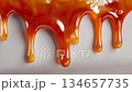 Close up of dripping golden caramel syrup 134657735