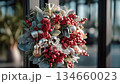 A sparkling silver-red Christmas wreath brings out the warmth of winter festivities. 134660023