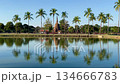 World Heritage Site Sukhothai: Wat Sassi and cyclists reflected in the river 134666783