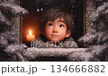 A boy looks out the window at the falling fluffy snow, a candle burns behind him, a cartoon about Christmas magic and a miracle on Christmas Eve 134666882