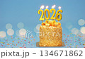Happy New Year 2026, seamless loop of cute cake with golden ribbon with candle number 2026 for new year celebrate party was lit. blue background with light bokeh, horizontal 134671862