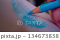 Close-up shot of hand drawing abstract pattern on paper with blue pencil 134673838