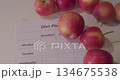 diet Plan. diet plan and a apples lying on a table 134675538