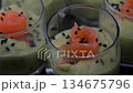 Smoked salmon shot glasses guacamole served with homemade crackers 134675796