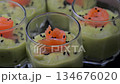 Smoked salmon shot glasses guacamole served with homemade crackers 134676020