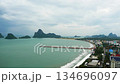 Beautiful blue sea with mountain with bridge with coastal town and green island, Aerial view of beach at Prachuap Bay, Prachuap Khiri Khan, Thailand 134696097