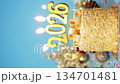 Happy New Year 2026, seamless loop of cute cake with golden ribbon with candle number 2026 for new year celebrate party was lit. decorate with Christmas ornament at blue background, vertical 134701481