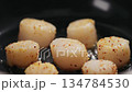 Slow motion frying scallops on a ceramic pan 134784530