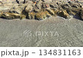 Slow motion shot of sea waves hitting the rocks at beach daytime 134831163