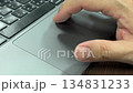 Close-Up of Hand Using Finger to Click and Scroll on a Laptop Trackpad 134831233