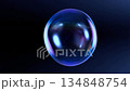Bubble in Blue: A captivating soap bubble, glistening with iridescent colors, floats gently against a deep blue backdrop, showcasing its fragile beauty and ephemeral nature. 134848754