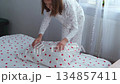 A girl makes her bed. High quality 4k footage 134857411