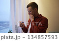 Happy young man feeling overwhelmed with emotion and crying with joy after seeing a positive pregnancy test, anticipating the exciting news of becoming a father and starting a new family 134857593