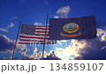 Flags of the United States and Idaho Waving Against Dramatic Sky at Sunset 134859107
