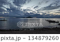 Two fishermen and an abandoned pier in autumn on the Aegean Sea; a time-lapse of a cloudy sunset. 134879260