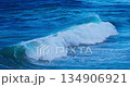 Powerful Ocean Wave Crashing in a Dynamic Display of Blue Water and Foaming Spray 134906921