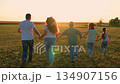Mother father child kid run green meadow sunset, happy family, silhouette cheerful team group people, and golden hour magic., open skies, loving household steps forward as one beneath expansive 134907156