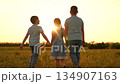 Happy children run towards sunset, girl boy holding hands run play, fun summer holidays, children recreation, boys and girls, warm heartfelt connection, siblings holding hands, warm summer breeze 134907163