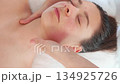 Young woman relaxing with rejuvenating facial 134925726