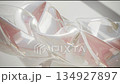 Abstract glossy blurry background, moving shiny waves against the sunlight, modern plastic futuristic backdrop 134927897