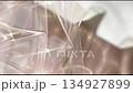 Abstract glossy blurry background, moving shiny waves against the sunlight, modern plastic futuristic backdrop 134927899