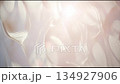Abstract glossy blurry background, moving shiny waves against the sunlight, modern plastic futuristic backdrop 134927906