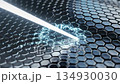 A bright beam of light cuts through a dark hexagonal grid structure 134930030