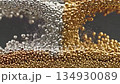 Close up of silver and gold magnetic spheres interacting with each other 134930089