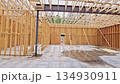 Wooden beams framework progress on construction site with concrete floor 134930911