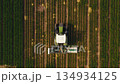 aerial drone view of harvesting with combine tractor. picking, industrial, production, agriculture 4.0, farm machine, agricultural equipment, forage harvester 134934125