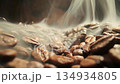 Roasting coffee beans process with smoke rising in slow motion from freshly roasted seeds on dark background, sliding view 134934805