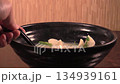 Enjoying delicious dumplings in warm broth at a cozy kitchen setting on a chilly evening 134939161