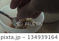 Crunchy breakfast delight with granola and fresh fruit in a cozy kitchen setting 134939164
