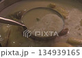 Discover the rich flavors of homemade coconut chicken curry crafted in a rustic kitchen 134939165