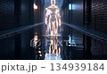Glowing human figure in dark alleyway with reflective wet floor 134939184