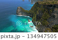 Aerial view of scenic cliffs and turquoise water on Nusa Penida Island, Bali, Indonesia. Stunning landscape ideal for travel, nature, and tropical paradise themes. 134947505