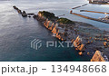 Aerial view of Hashigui Rock and Kushimoto Town in the morning light, taken with a reversing ascent by drone 134948668