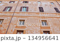 Charming Roman Building With Traditional Shuttered Windows And Historic Facade 134956641
