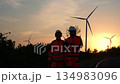 Two engineer working at a wind turbine power generation site. 134983096