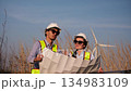 Two engineer working at a wind turbine power generation site. 134983109