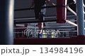 Cropped footage captures the silhouette of a male boxer mastering jump rope agility and speed in a dimly lit boxing gym, showcasing focused training and fluid motion. Slow motion 4K video. 134984196