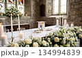 White Flowers and Candles Arranged for First Communion Ceremony 134994839