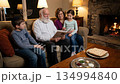 Grandparents Sharing Story with Grandchildren During Passover Evening 134994840