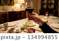 Hands Holding Wine Glass During Passover Ritual Moment 134994855