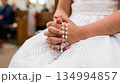 Close Up of Hands Holding Rosary During First Communion 134994857